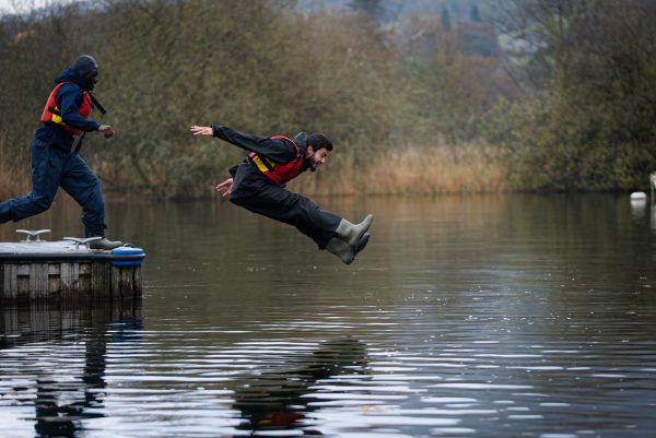 Zain - StreetGames young advisor, jumping into a body of water, wearing a lifejacket and water proof clothing